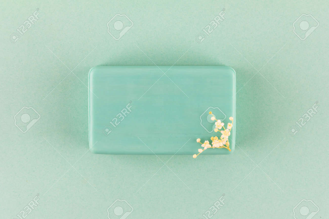 handmade soap bar with small white flowers on a green background top view - 169308571 handmade soap bar with small white flowers on a green background top view - 169308571