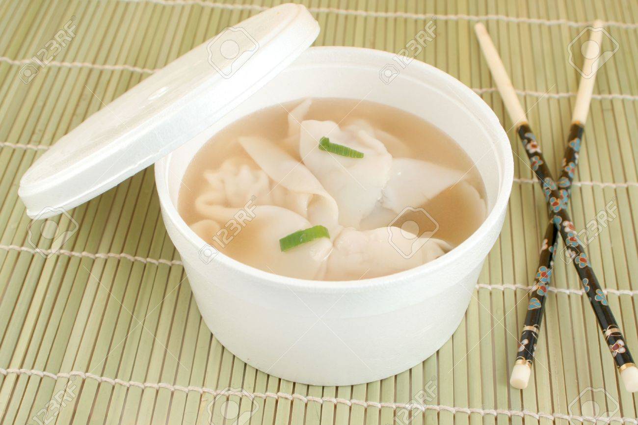 Takeout Container Of Chinese Wonton Soup With Chopsticks On A Green Bamboo Placemat Stock Photo Picture And Royalty Free Image Image