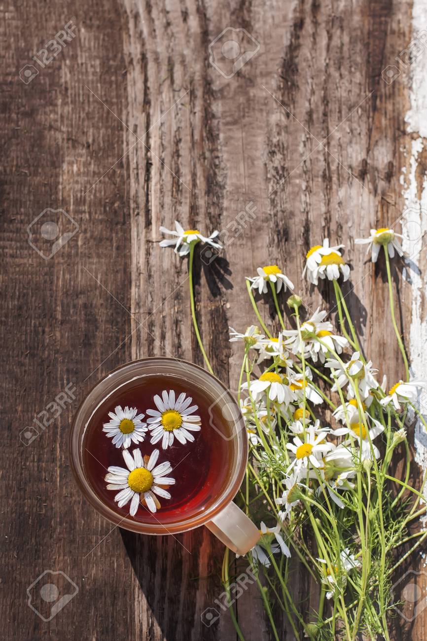 cup of chamomile tea with chamomile flowers, old wood table background - 42444838 cup of chamomile tea with chamomile flowers, old wood table background - 42444838