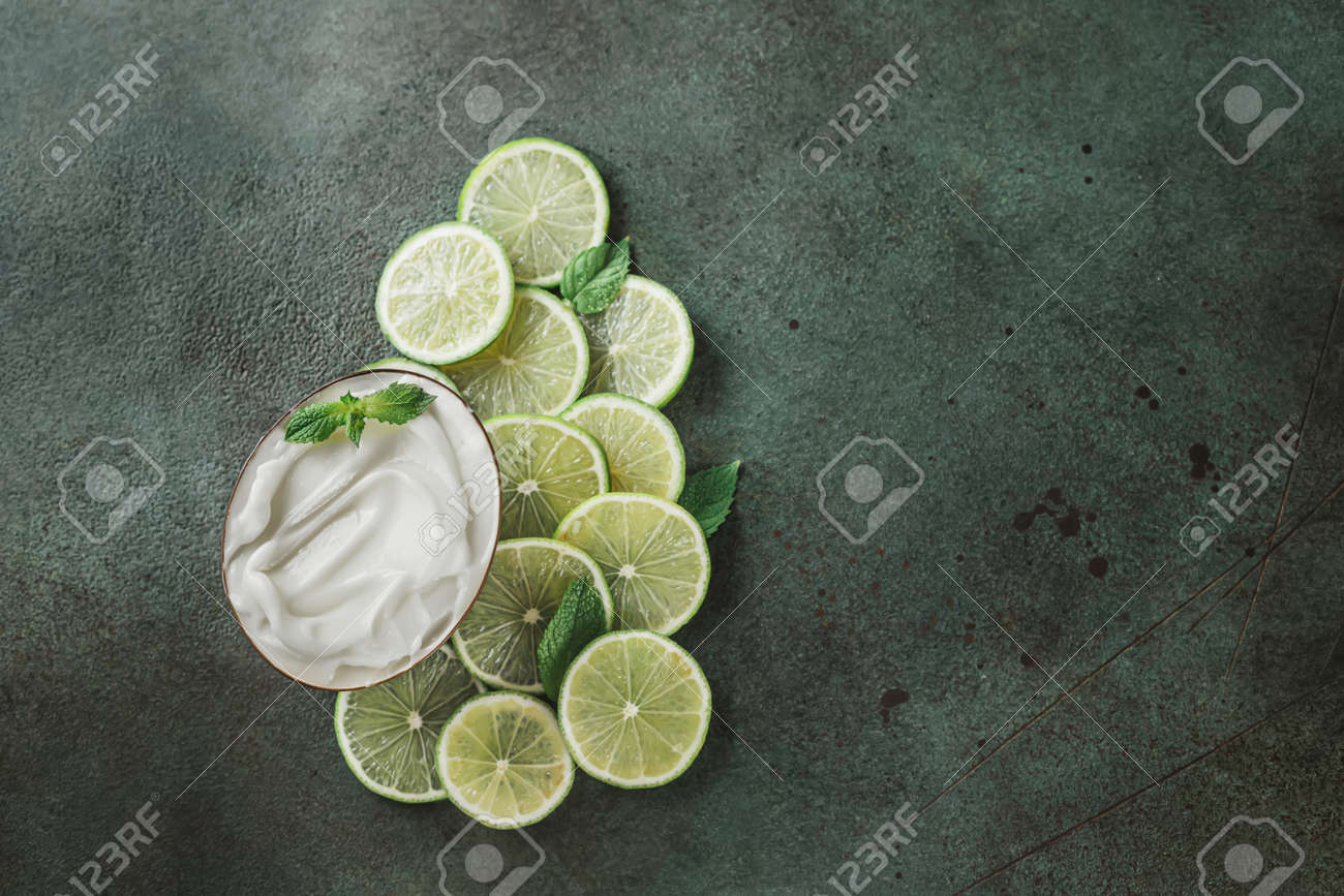 Jar with cosmetic product with lime and mint halves on green concrete. Natural citrus cosmetics with vitamin C. Copy space. - 171871487 Jar with cosmetic product with lime and mint halves on green concrete. Natural citrus cosmetics with vitamin C. Copy space. - 171871487