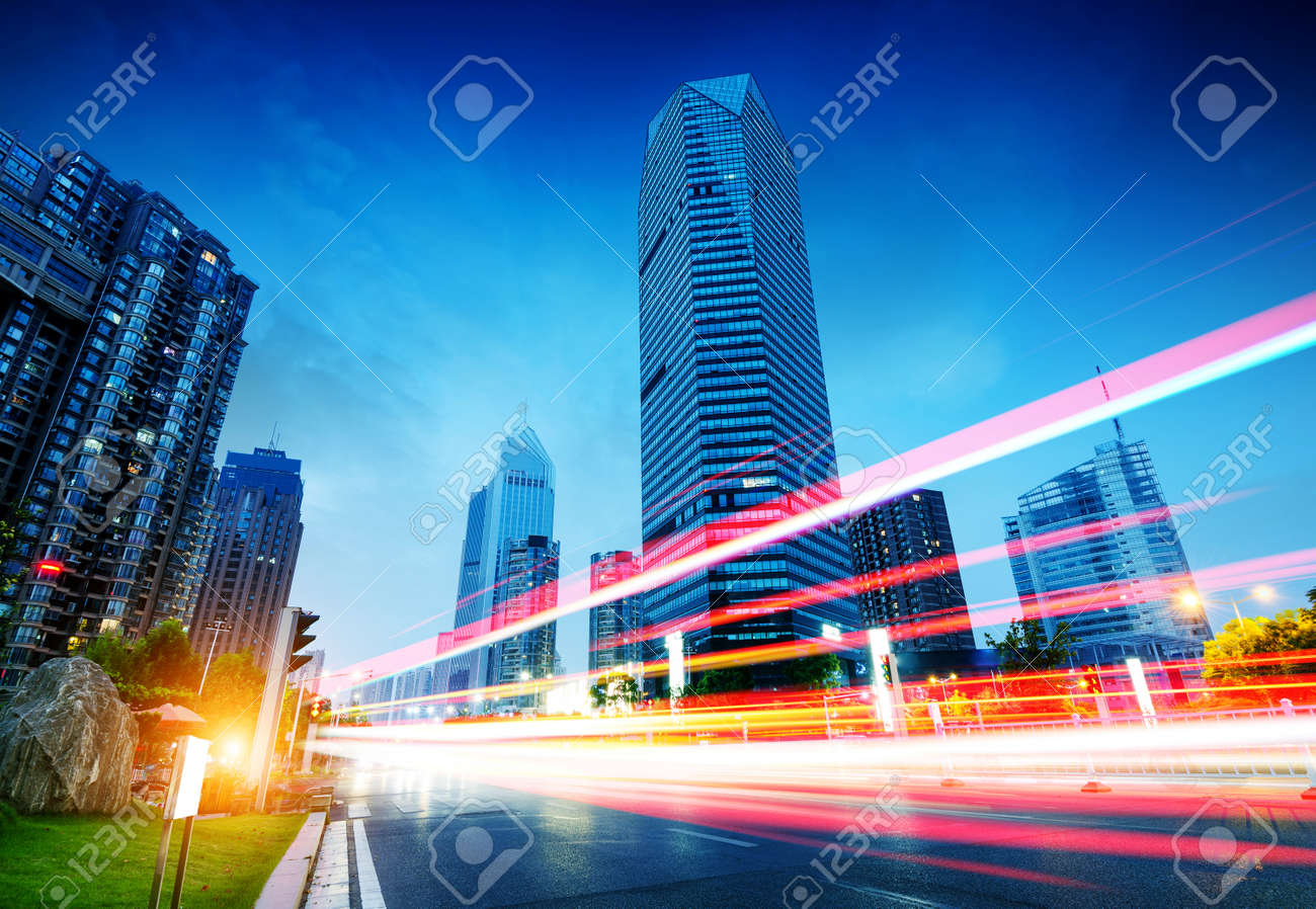 The light trails on the modern building background in shanghai china. - 47624005 The light trails on the modern building background in shanghai china. - 47624005