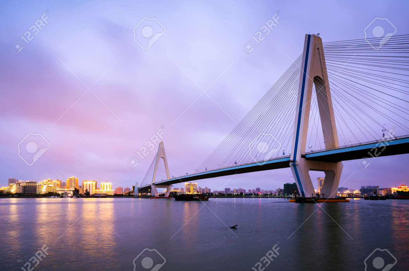 City skyline and sea bridge at night, Haikou, Hainan, China - 101271253 City skyline and sea bridge at night, Haikou, Hainan, China - 101271253