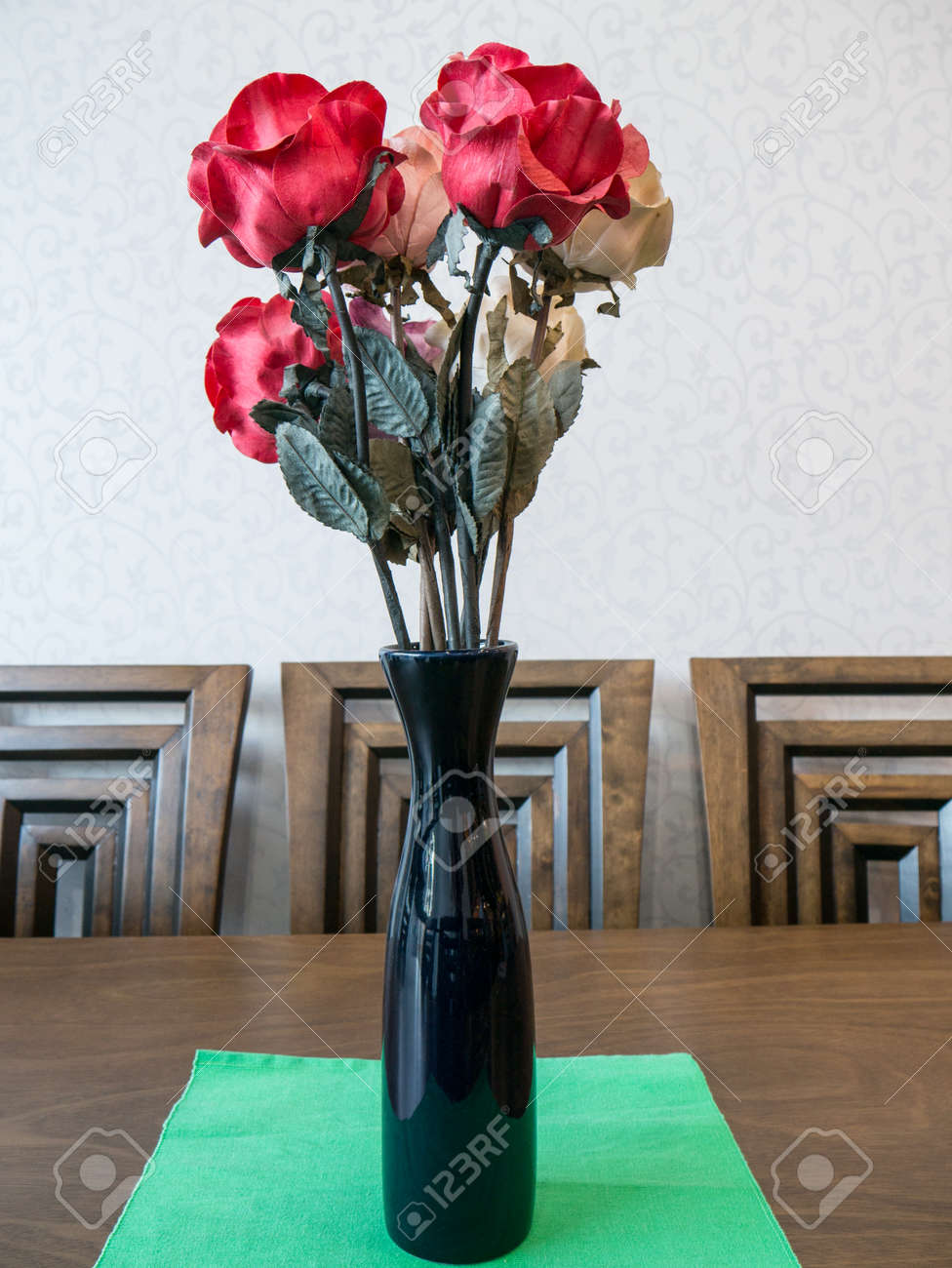 Bouquet Of Artificial Red Rose Flower In Vase On Table Stock Photo