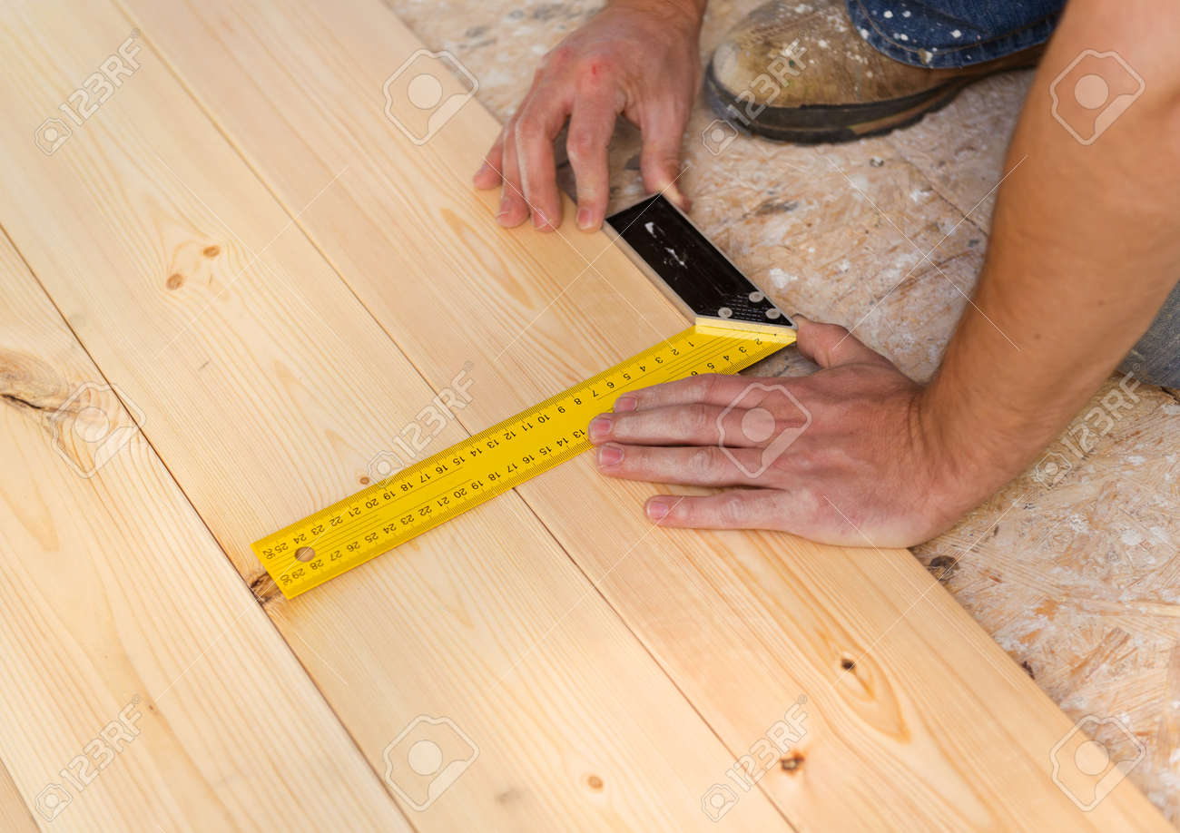 Close Up Of Male Hands Measuring Wood Flooring Stock Photo Picture Close Up Of Male Hands Measuring Wood Flooring Stock Photo 29021512