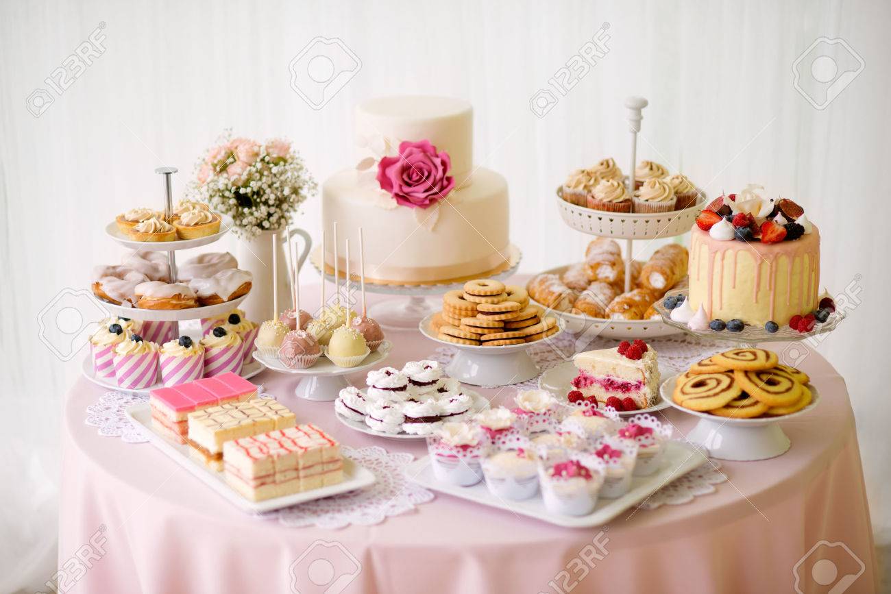 Table with loads of cakes, cupcakes, cookies and cakepops. Studio..
