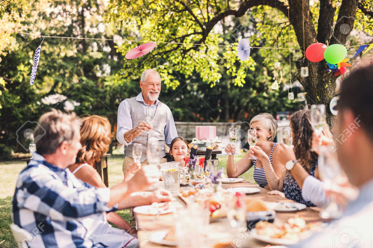 Family celebration or a garden party outside in the backyard. - 97646943 Family celebration or a garden party outside in the backyard. - 97646943