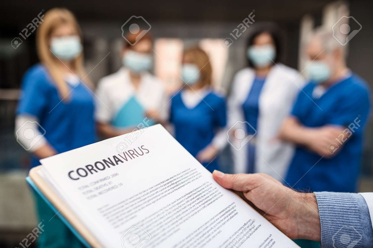 Group of doctors talking about corona virus on conference. - 139930802 Group of doctors talking about corona virus on conference. - 139930802