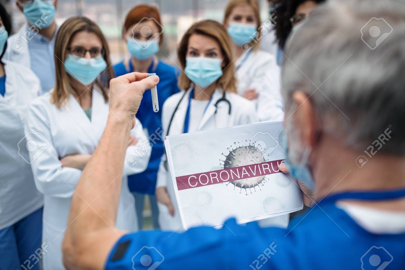 Group of doctors talking about corona virus on conference. - 139930735 Group of doctors talking about corona virus on conference. - 139930735