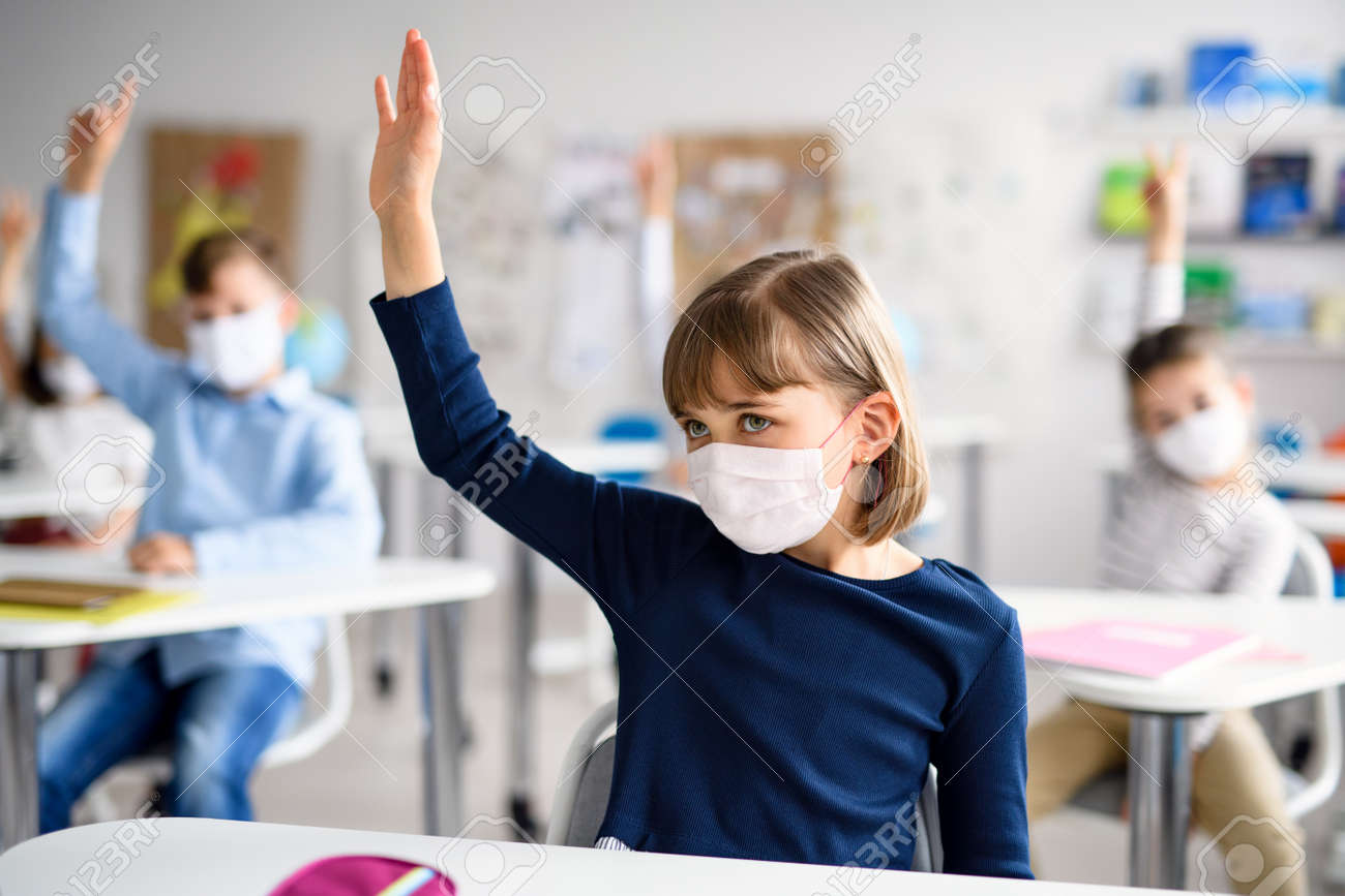Child with face mask back at school after covid-19 quarantine and lockdown. - 148162914 Child with face mask back at school after covid-19 quarantine and lockdown. - 148162914