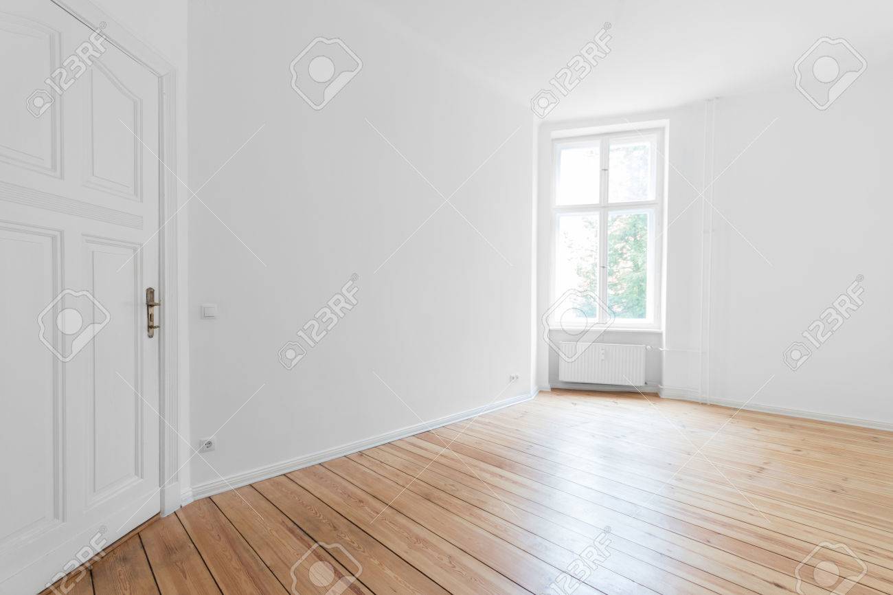 empty room in a new apartment with wooden floors and white walls and a  serious mildew and mold problem