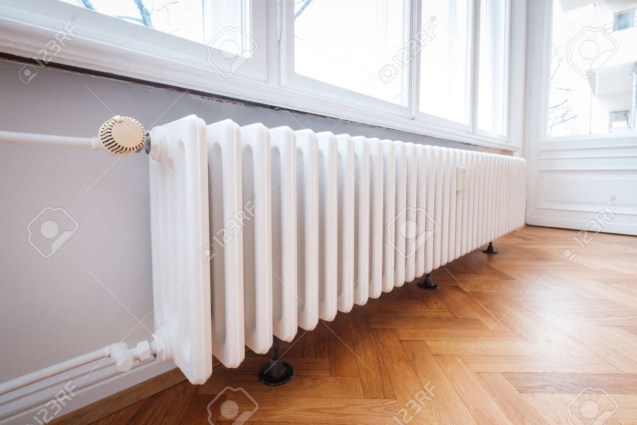 Radiator And Thermostat In Flat Heater Closeup Stock Photo