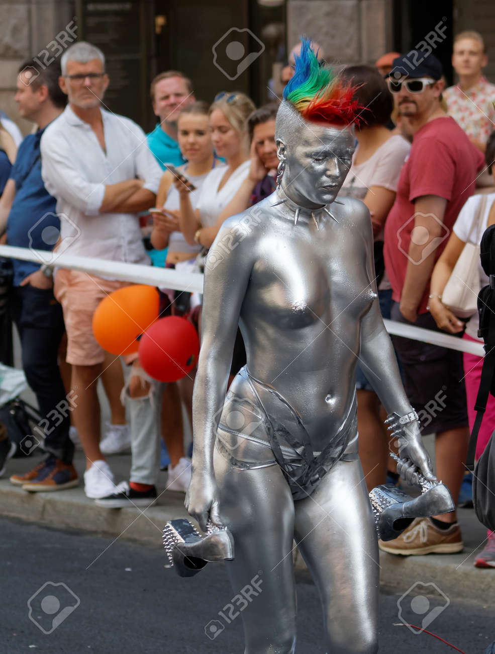 woman during go naked pride parade STOCKHOLM, SWEDEN - JUL 30, 2016: Half Naked Woman Covered With Silver Body  Painty And Rainbow Colored Hair, Front View In The Pride Parade July 30,  2016 In Stockholm, Sweden Stock Photo,