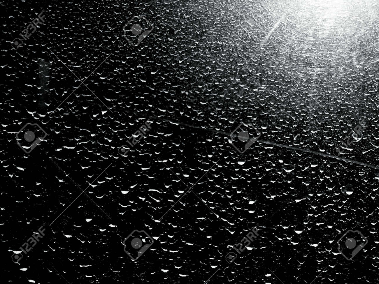 duster or raindrop on the metal dooor with sunlight in black stock