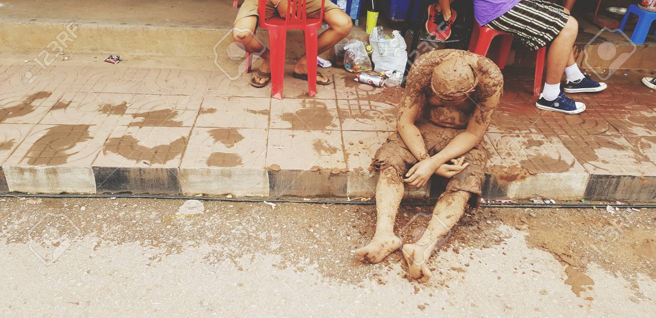 129268592-loei-thailand-july-6-2019-adult-or-old-man-stained-the-mud-sitting-and-asleep-at-the-footpath-look-l.jpg