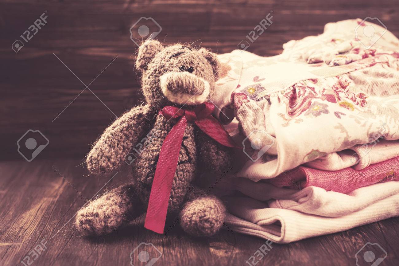 teddy bear with baby clothes