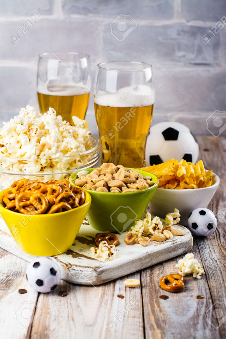 beer and snacks on wooden table football season or fans party