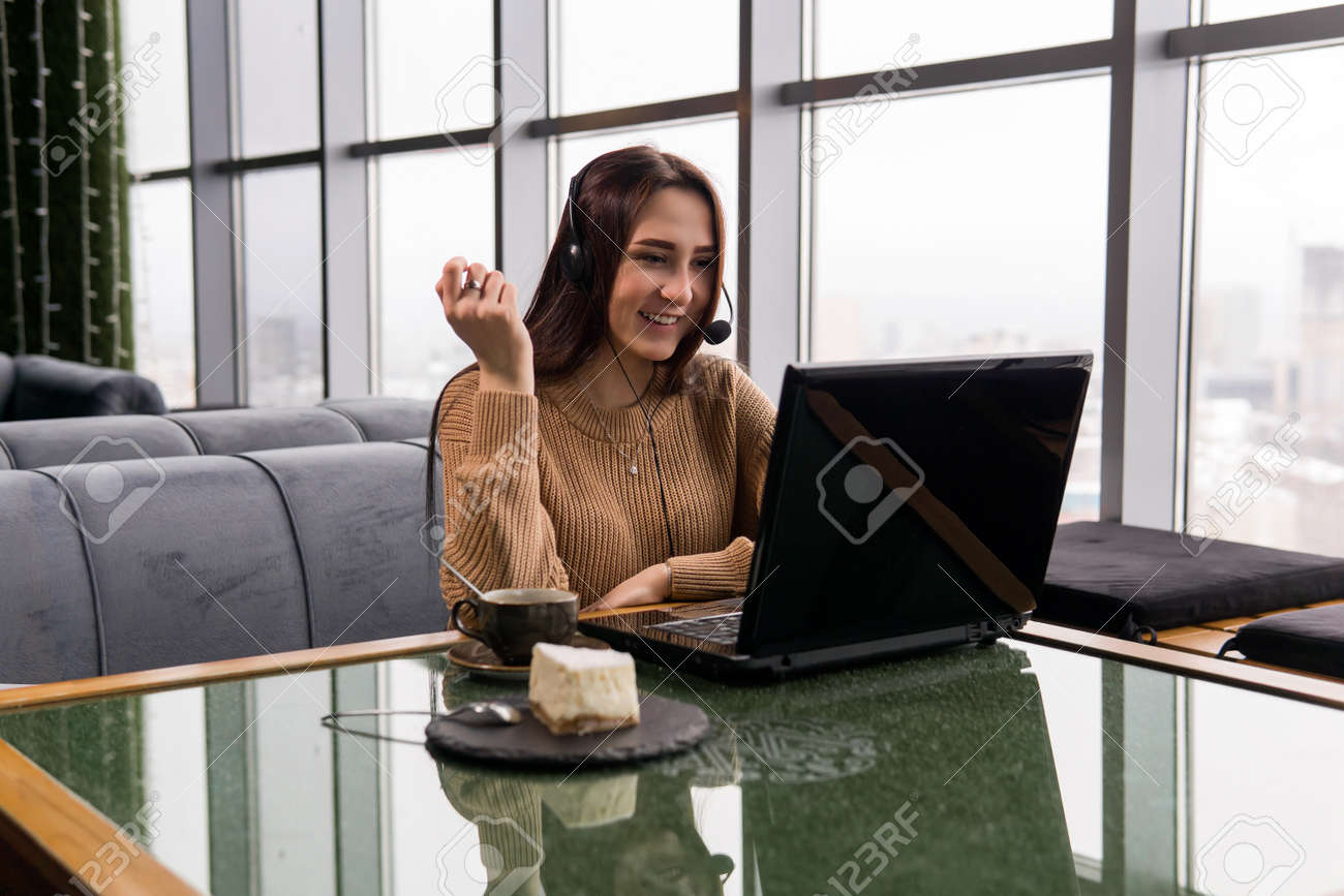 girl leads an amateur online broadcast from the coffee shop - 136467963 girl leads an amateur online broadcast from the coffee shop - 136467963