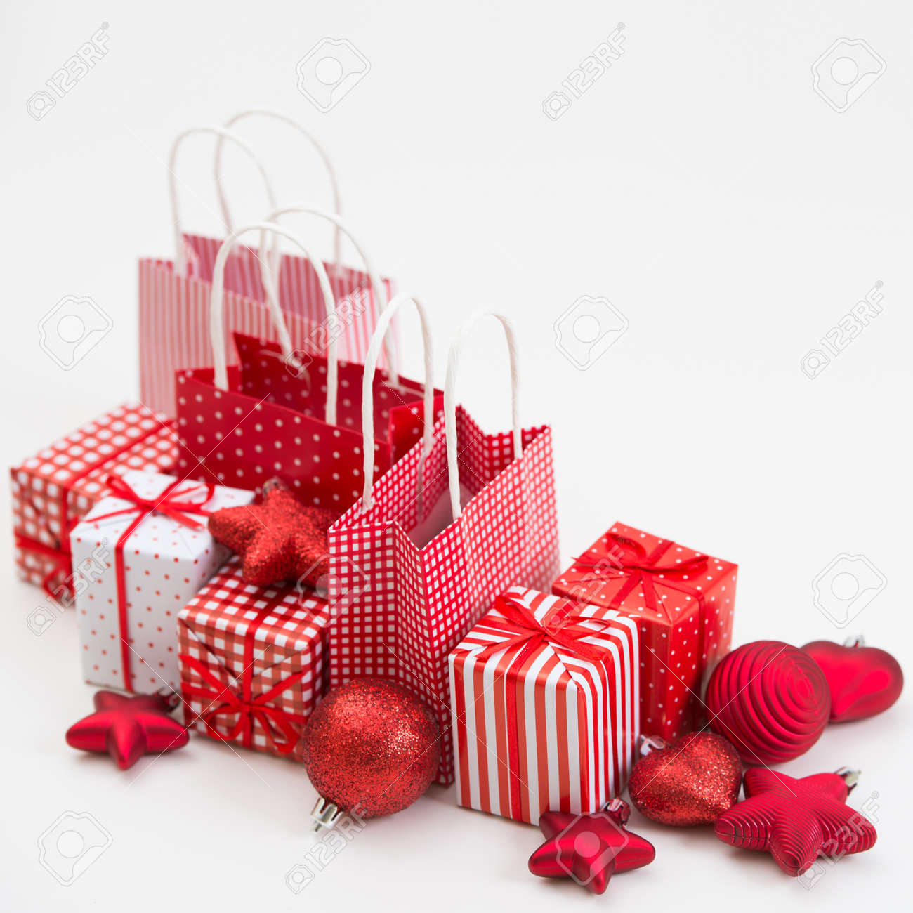 gift boxes with xmas presents wrapped in red paper with ornament on white background lots - Xmas Presents gift boxes with xmas presents wrapped in red paper with ornament on white background lots - Xmas Presents