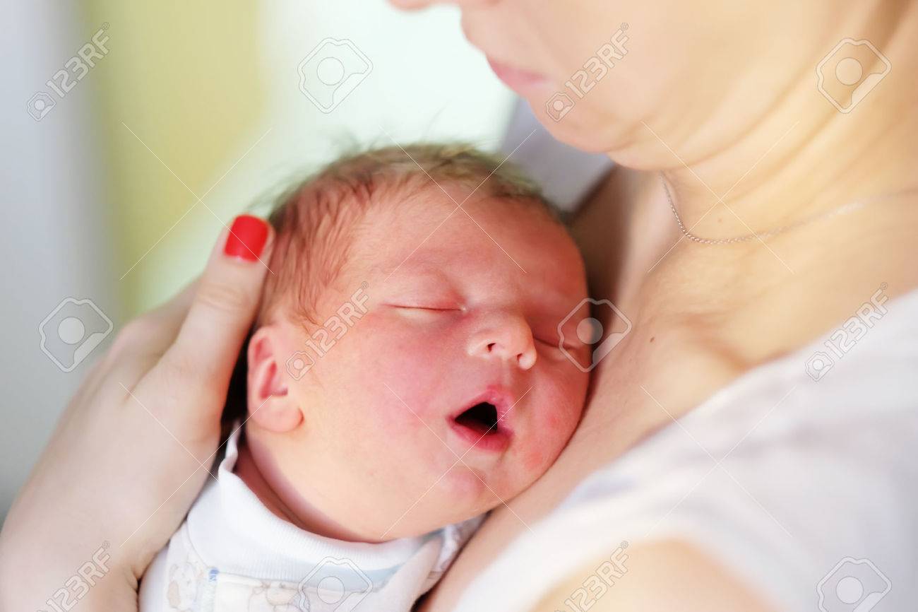 One day old newborn baby with his mother stock photo 49562341