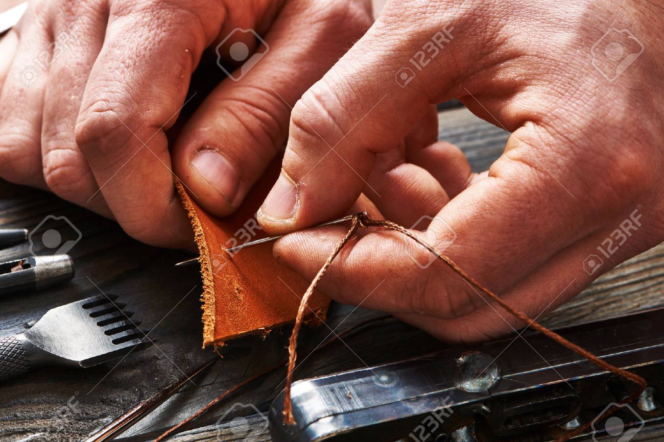 Man working with leather using crafting DIY tools - 52209001 Man working with leather using crafting DIY tools - 52209001