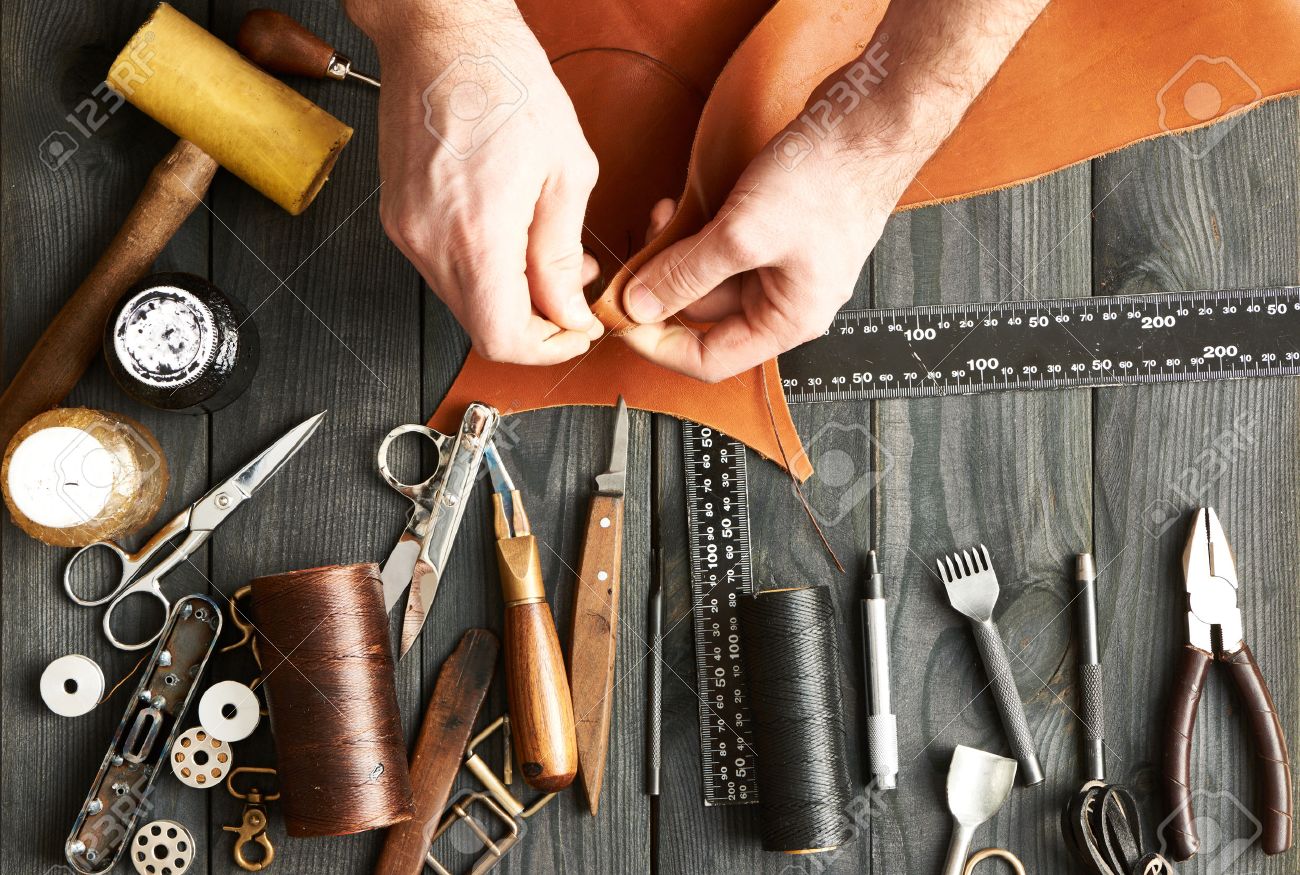 Man working with leather using crafting DIY tools - 52916325 Man working with leather using crafting DIY tools - 52916325