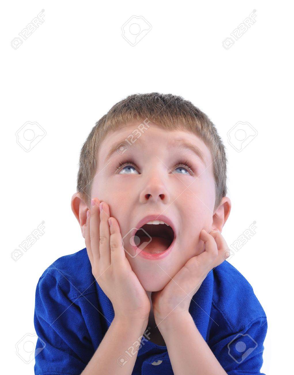 A Little Boy Is Looking Up With His Mouth Open And Hands On His