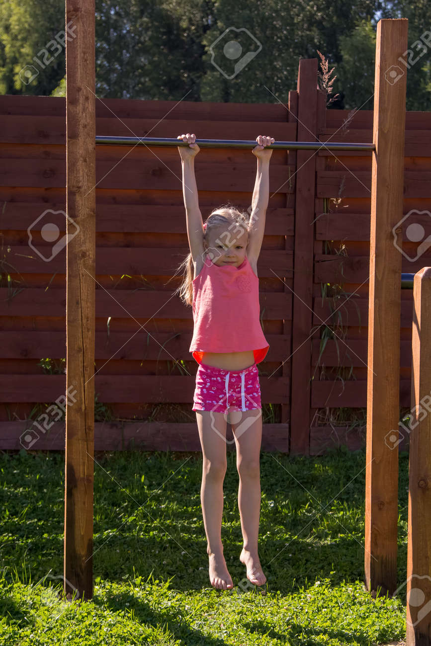 little girl hanged Little Girl Hanging On A Horizontal Bar Stock Photo, Picture and Royalty  Free Image. Image 125882540.