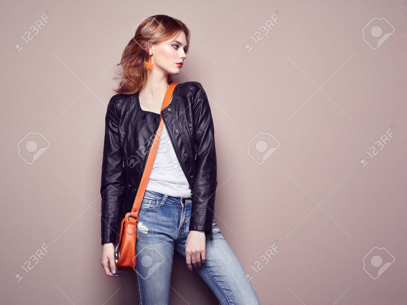 Fashion portrait of beautiful young woman with red hair. Girl in blouse and jeans. Jewelry and hairstyle. Girl with handbag - 58519885 Fashion portrait of beautiful young woman with red hair. Girl in blouse and jeans. Jewelry and hairstyle. Girl with handbag - 58519885