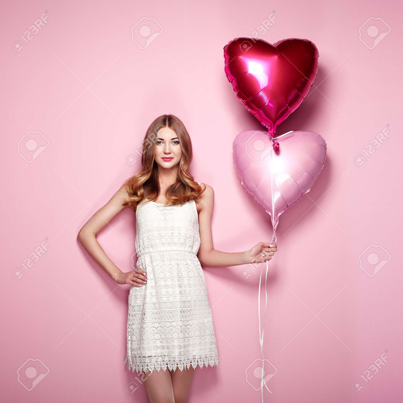 Beautiful young woman with heart shape air balloon on color background. Woman on Valentine's Day. Symbol of love - 70422942 Beautiful young woman with heart shape air balloon on color background. Woman on Valentine's Day. Symbol of love - 70422942