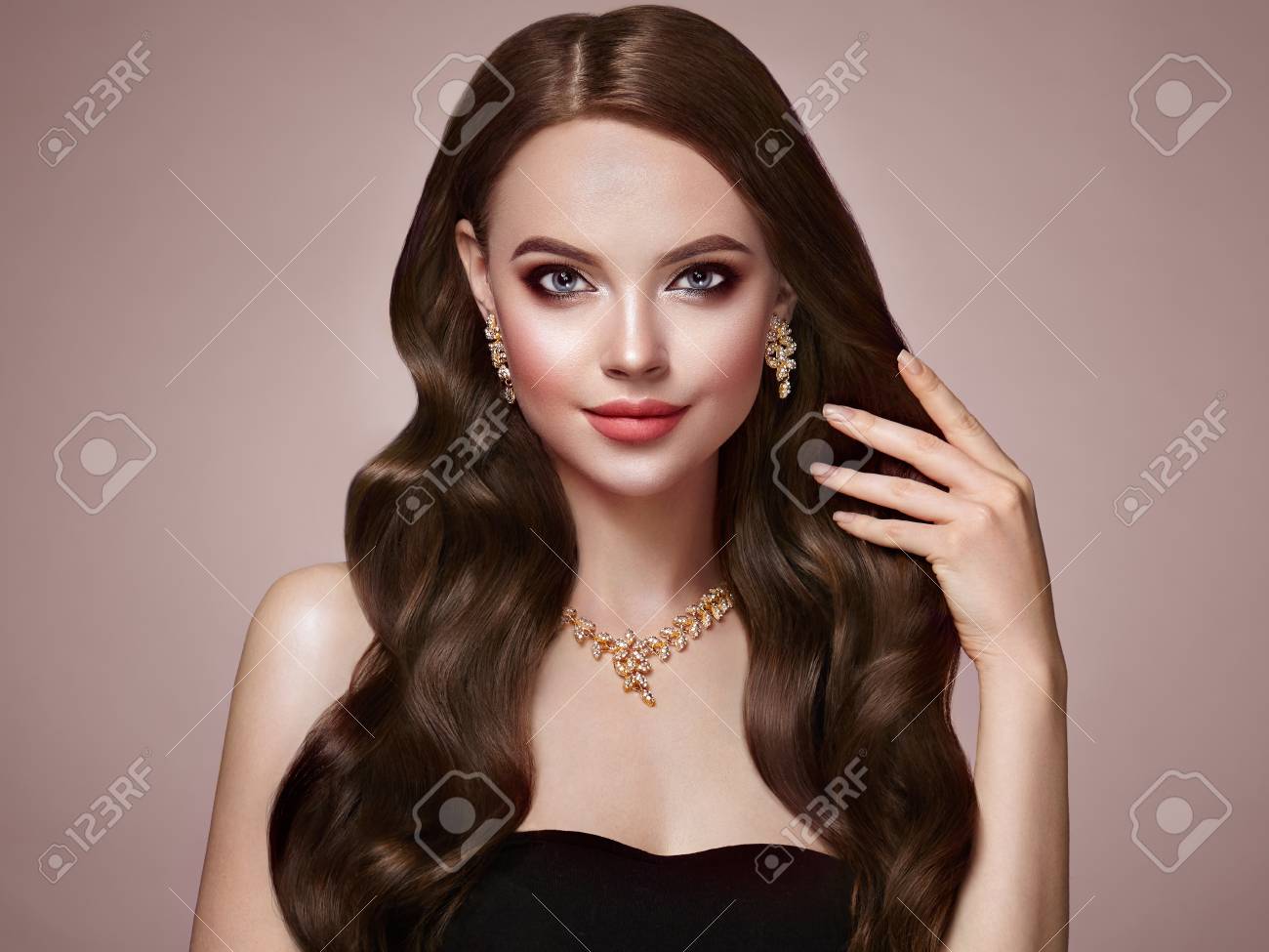 Brunette Girl with Long Healthy and Shiny Curly Hair. Care and Beauty. Beautiful Model Woman with Wavy Hairstyle. Make-Up and Jewelry - 103367398 Brunette Girl with Long Healthy and Shiny Curly Hair. Care and Beauty. Beautiful Model Woman with Wavy Hairstyle. Make-Up and Jewelry - 103367398