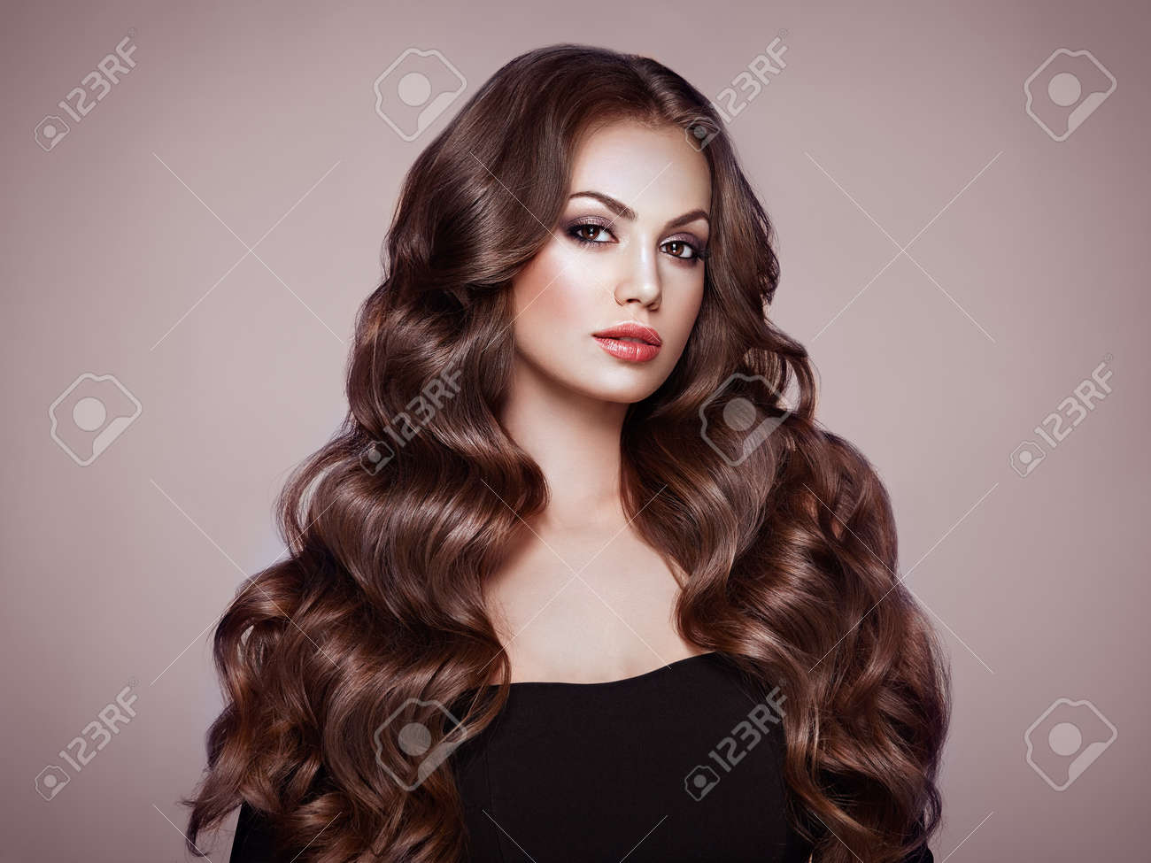 Brunette Girl with Long Healthy and Shiny Curly Hair. Care and Beauty. Beautiful Model Woman with Wavy Hairstyle. Make-Up and Black Dress - 112453340 Brunette Girl with Long Healthy and Shiny Curly Hair. Care and Beauty. Beautiful Model Woman with Wavy Hairstyle. Make-Up and Black Dress - 112453340