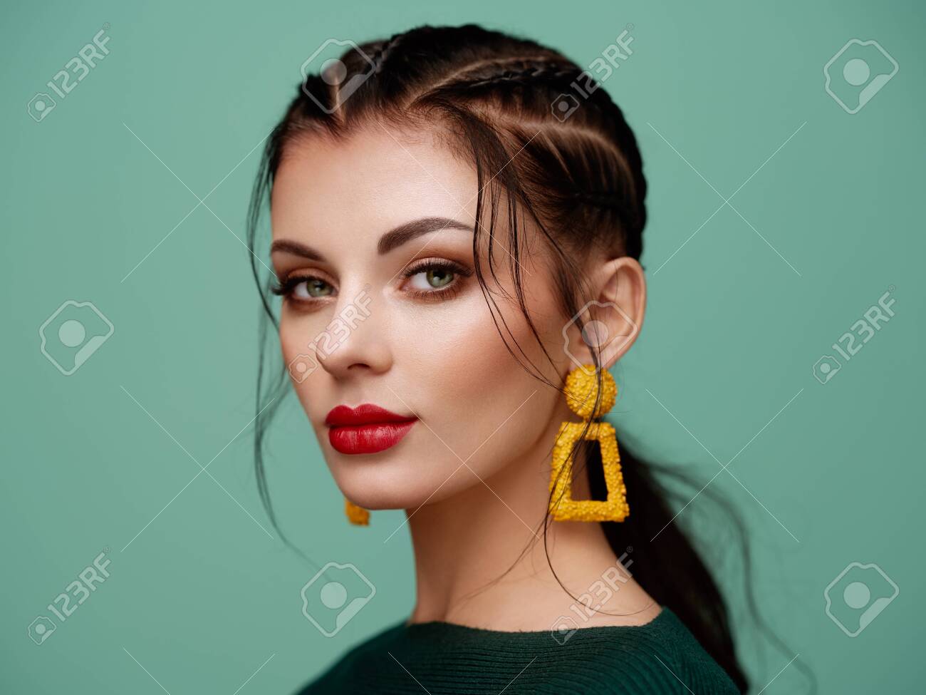 Brunette girl with perfect makeup. Beautiful model woman with curly hairstyle. Care and beauty hair products. Lady with braided hair. Model with jewelry. Turquoise background - 125293691 Brunette girl with perfect makeup. Beautiful model woman with curly hairstyle. Care and beauty hair products. Lady with braided hair. Model with jewelry. Turquoise background - 125293691