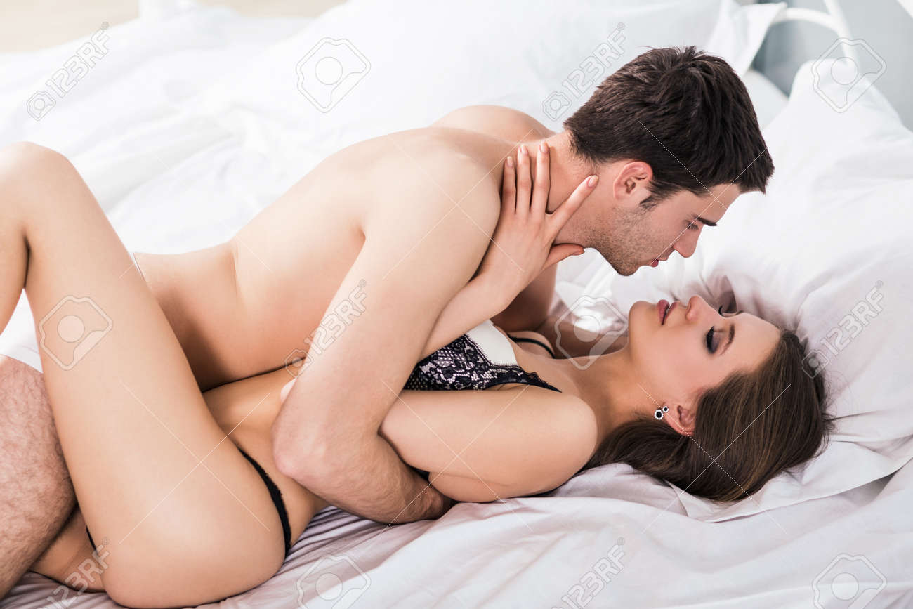 Young Romantic Couple Hugging And Kissing On A White Bed, Having Sex And  Being Loving With Each Other. Stock Photo, Picture and Royalty Free Image.  Image 51648018.