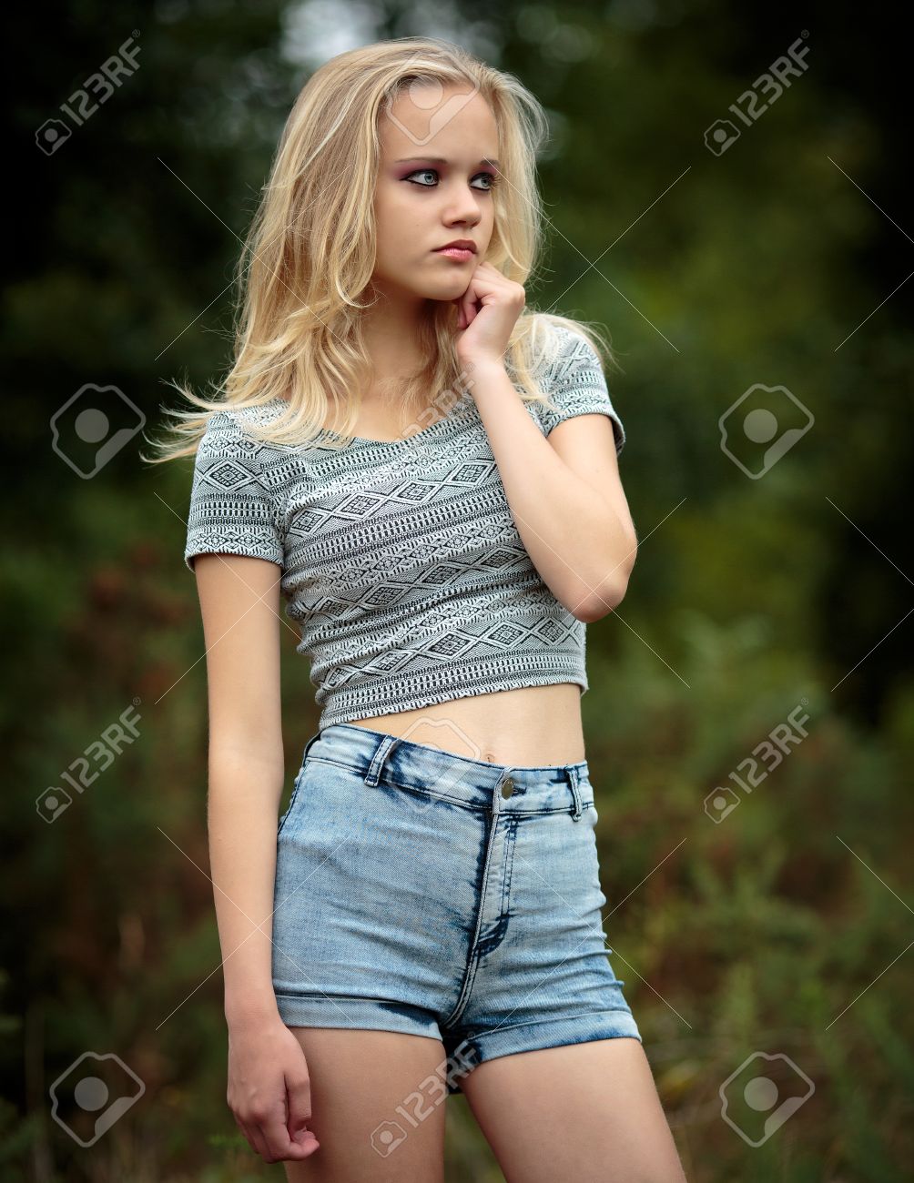 Location Portrait Of A Beautiful Young Blond Teenage Girl Alone In The Woods Wearing Denim Shorts Location Portrait Of A Beautiful Young Blond Teenage Girl Alone In The Woods Wearing Denim Shorts