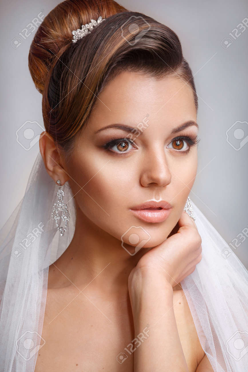 Beautiful Bride With Fashion Wedding Hairstyle On White