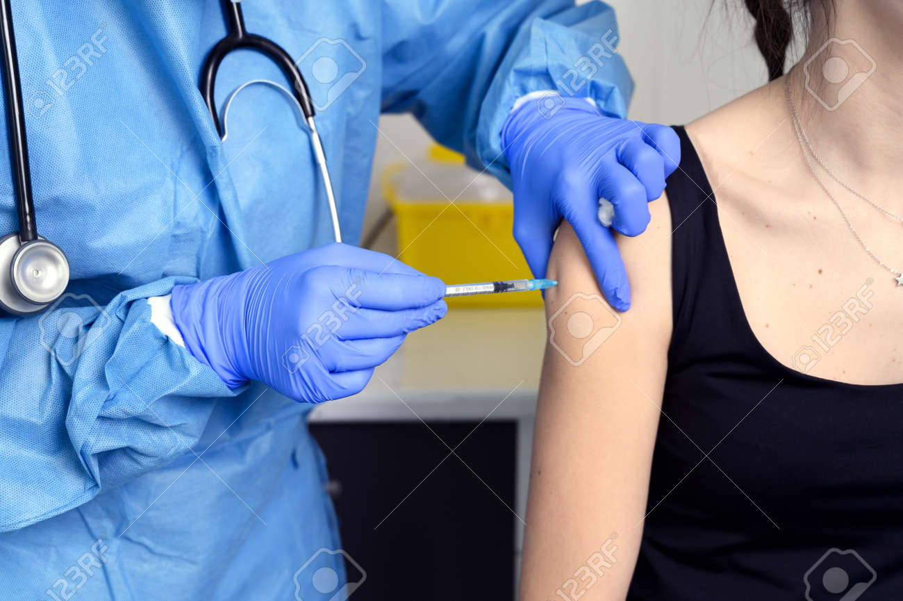 Close up of young woman getting vaccinated, concept. - 167629122 Close up of young woman getting vaccinated, concept. - 167629122