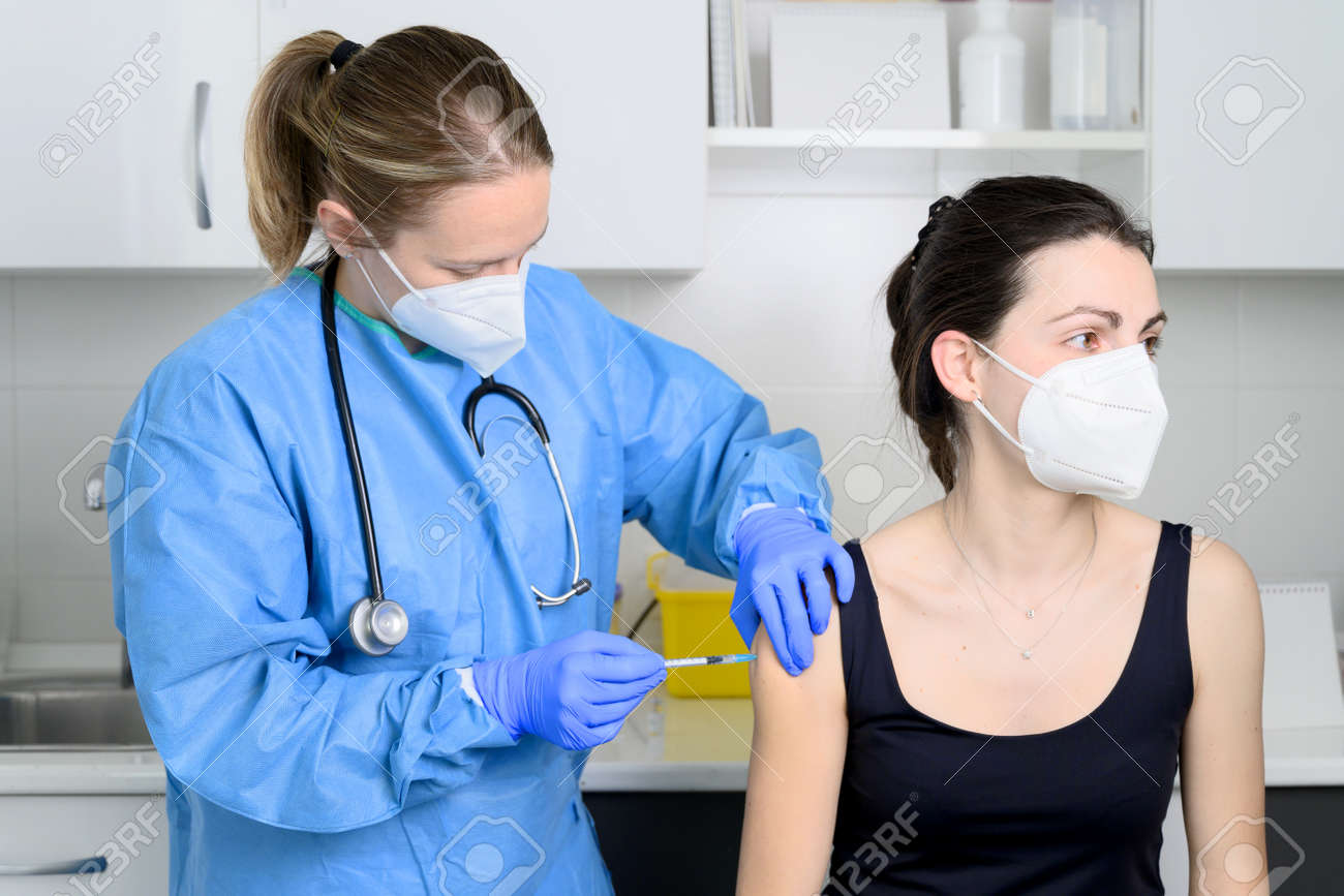 Close up of young woman with protective face mask getting vaccinated, concept. - 167629151 Close up of young woman with protective face mask getting vaccinated, concept. - 167629151