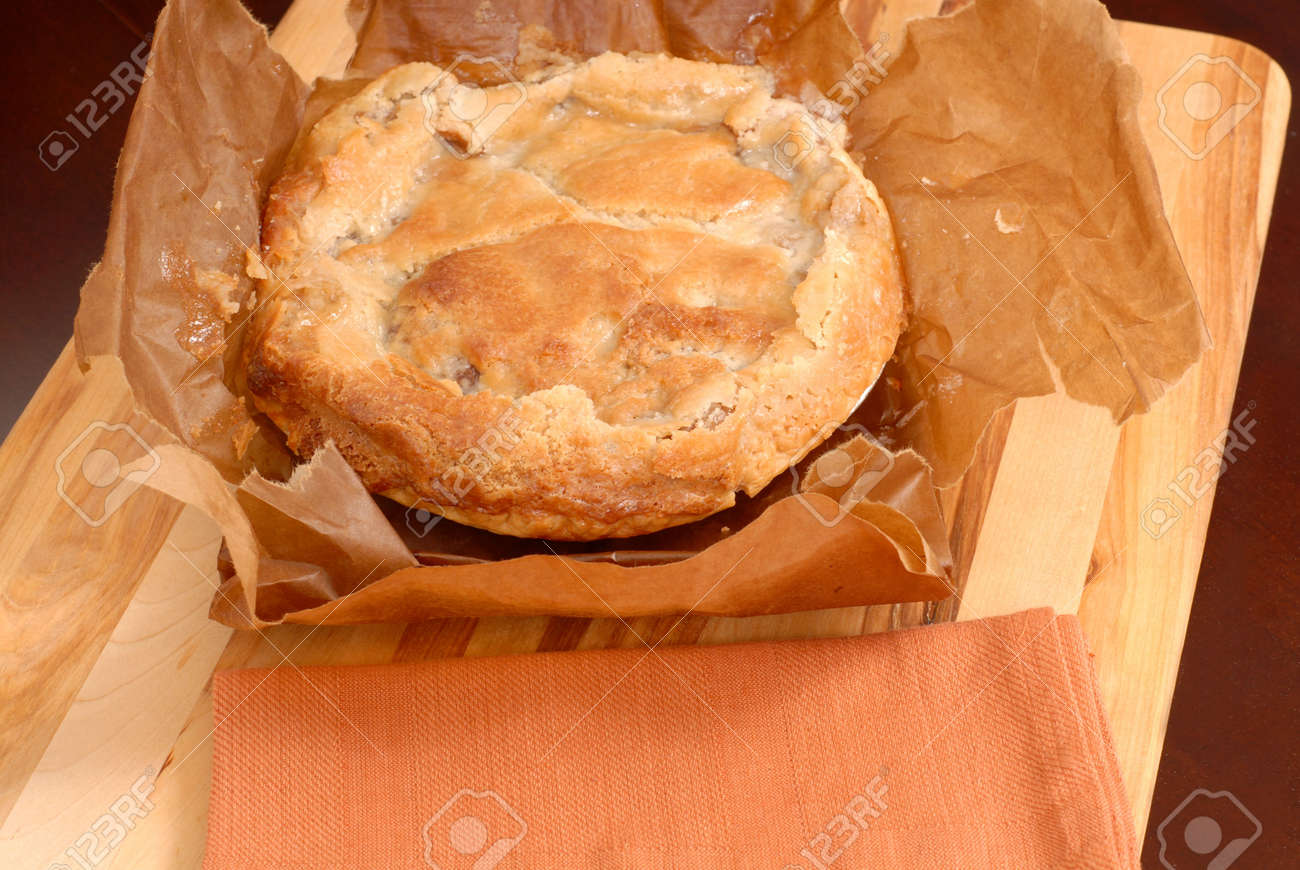 delicious paperbag apple pie on cutting board stock photo picture