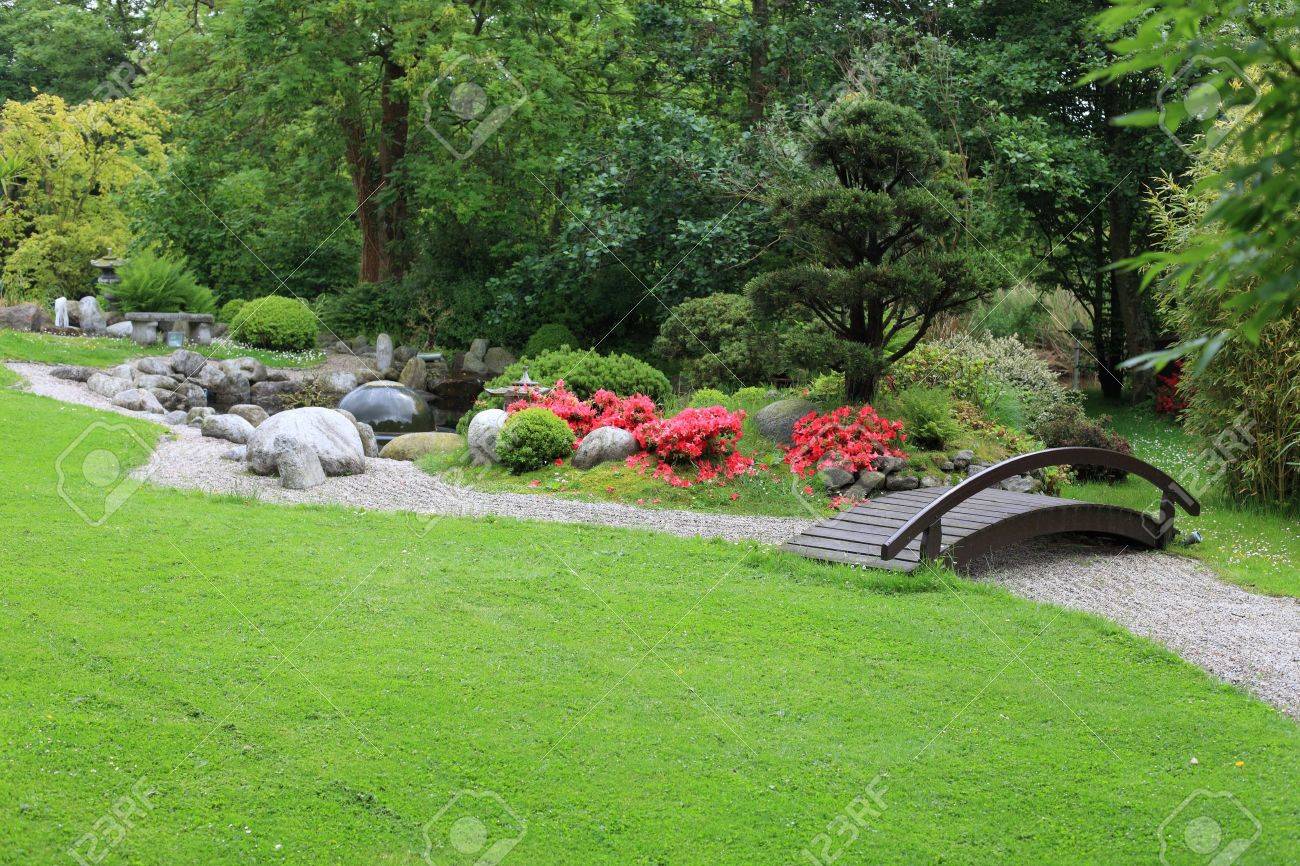 Chinese Backyard Design easy peasy Stock Photo Chinese Garden Korean Asian Japanese With A Wood Bridge And Some Colorful Nice Flowers And A Big Fresh Green Gras Meadow Chinese Backyard Design zen garden ideas in landscape asian design ideas with asian backyard Stock Photo Chinese Garden Korean Asian Japanese With A Wood Bridge And Some Colorful Nice Flowers And A Big Fresh Green Gras Meadow