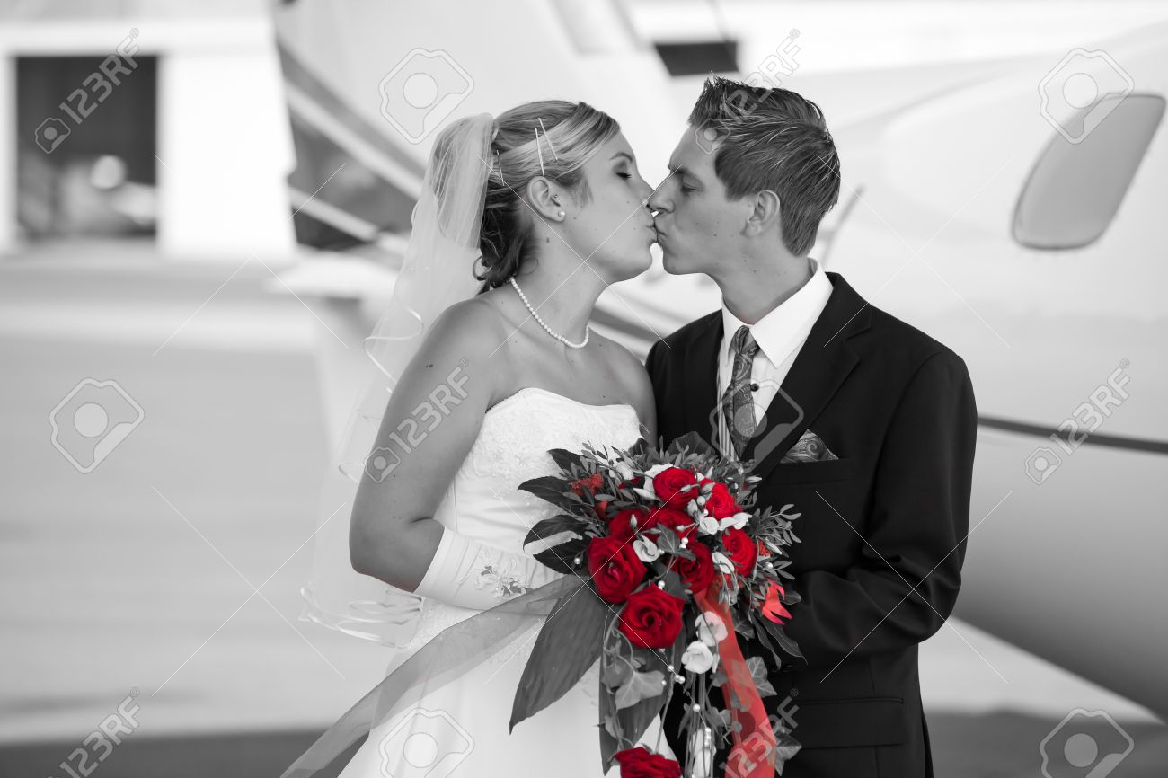 Black And White Wedding Photo With Colored Bunch Of Red Roses While Holding The Bouquet Black And White Wedding Photo With Colored Bunch Of Red Roses While Holding The Bouquet