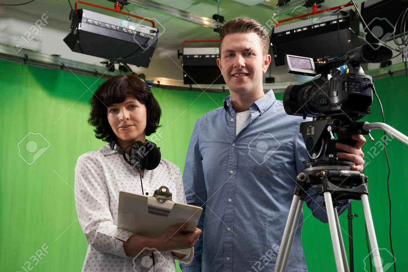 Portrait Of Cameraman And Floor Manager In Television Studio Stock