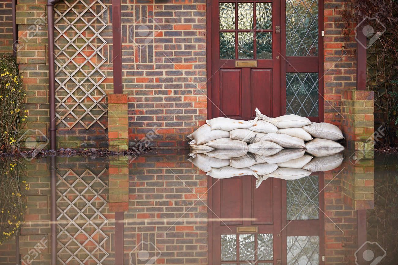 Sandbags Outside Front Door Of Flooded House - 49640689 Sandbags Outside Front Door Of Flooded House - 49640689
