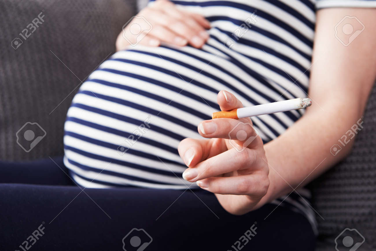 Close Up Of Pregnant Woman Smoking Cigarette - 54904974 Close Up Of Pregnant Woman Smoking Cigarette - 54904974