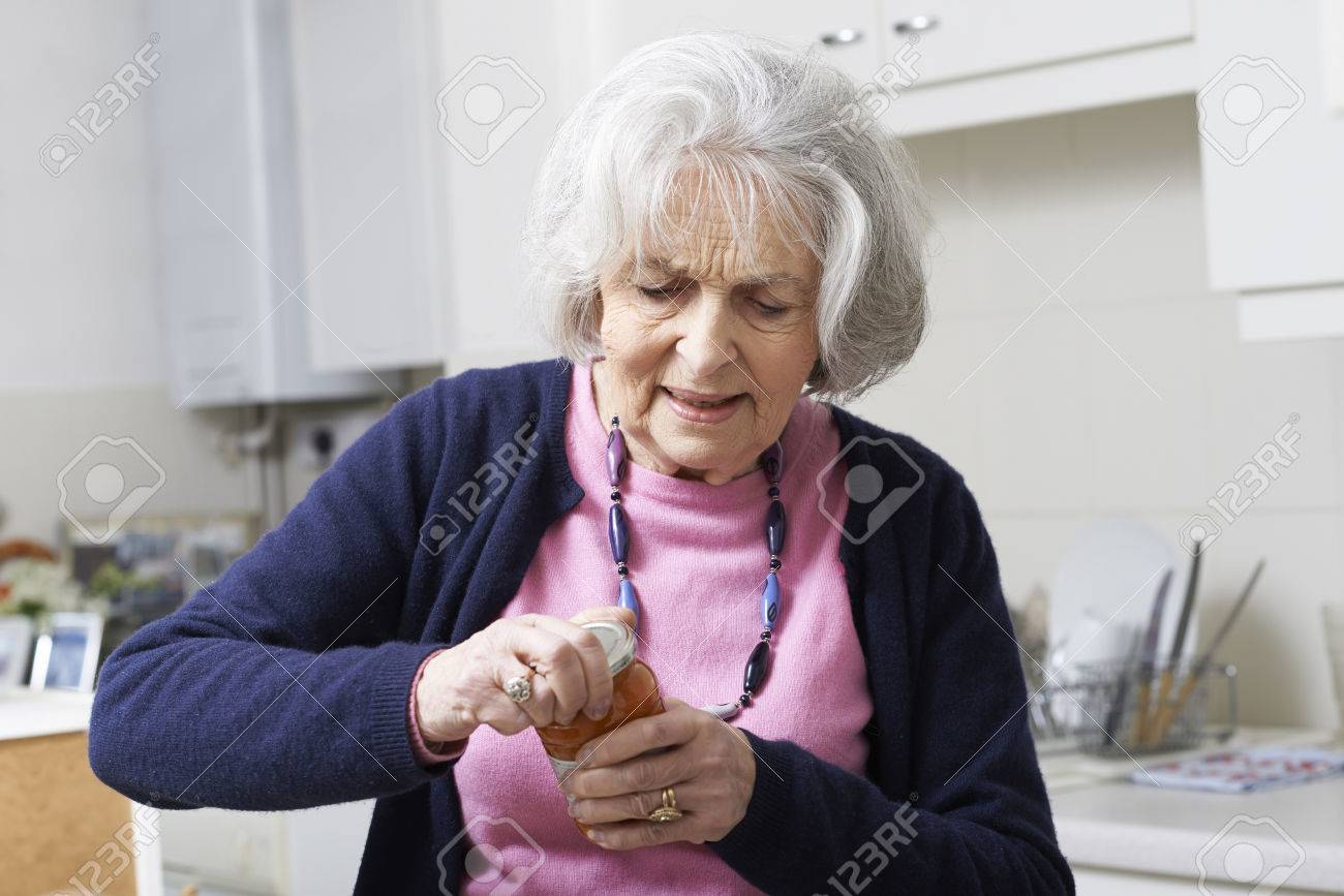 Senior Woman Struggling To Take Lid Off Jar - 57482778 Senior Woman Struggling To Take Lid Off Jar - 57482778