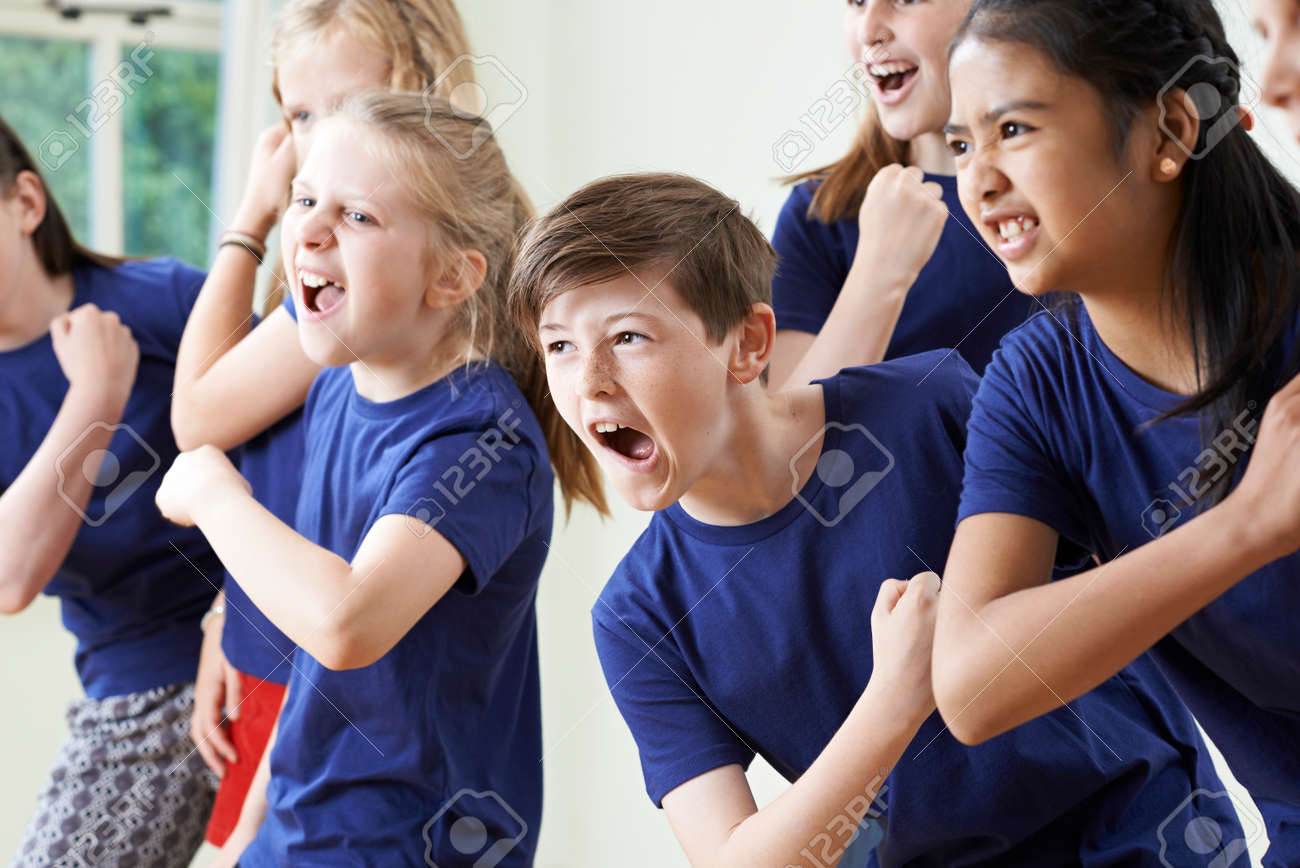 Group Of Children Enjoying Drama Class Together - 58983973 Group Of Children Enjoying Drama Class Together - 58983973