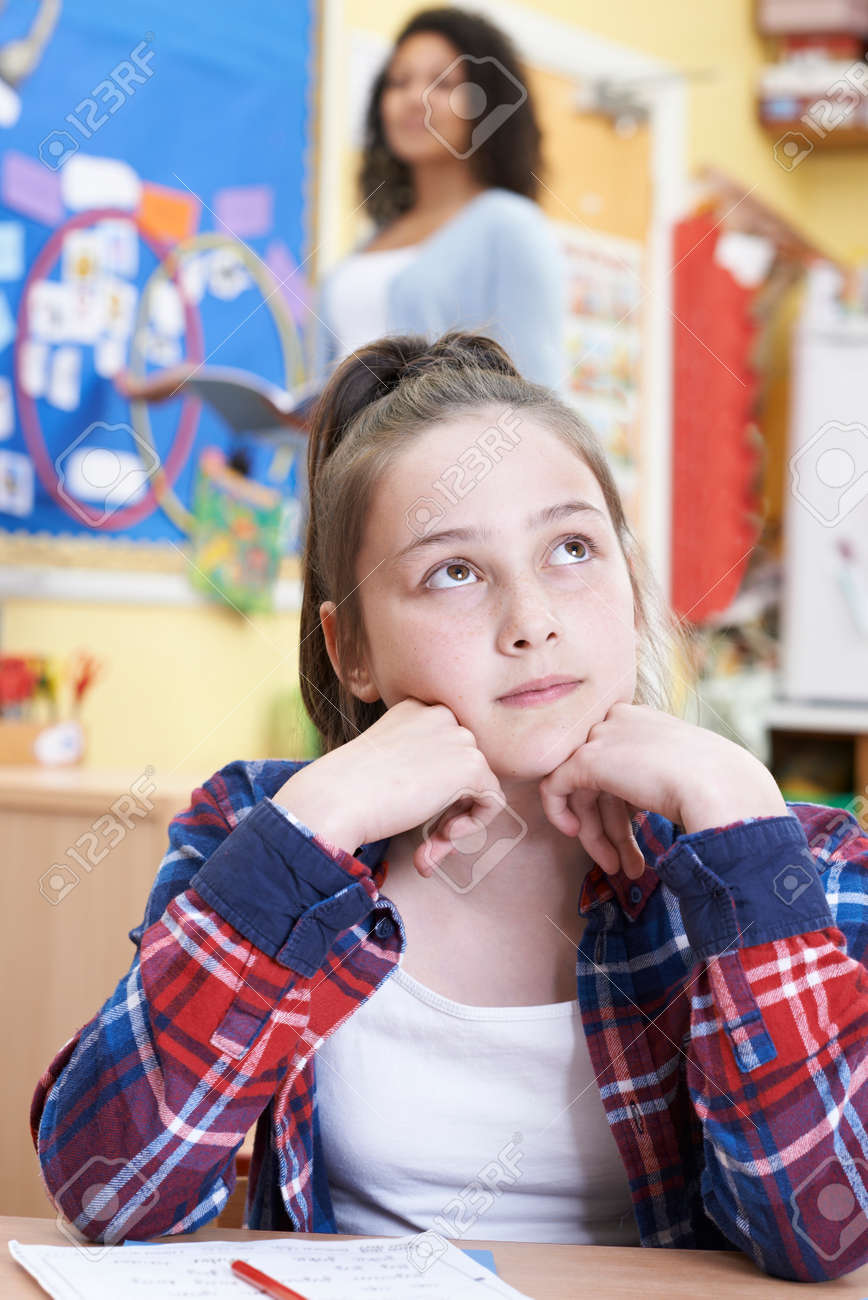 female elementary school pupil daydreaming in class stock photo daydreaming in class