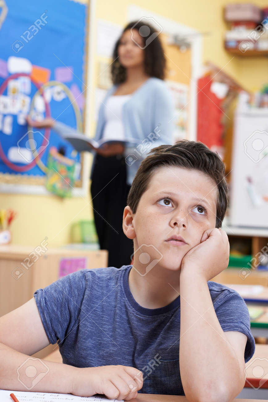 male elementary school pupil daydreaming in class stock photo daydreaming in class