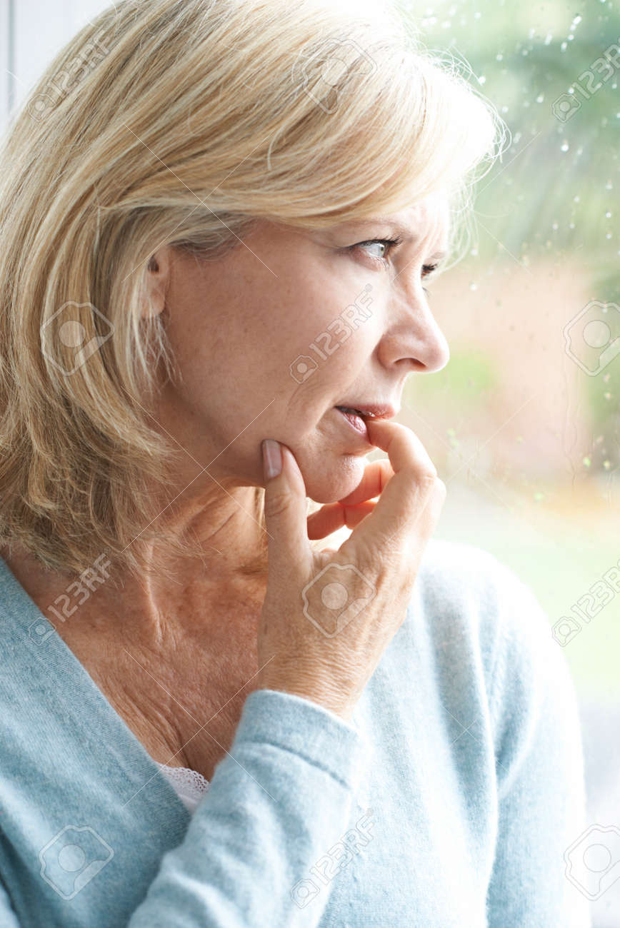 Sad Mature Woman Suffering From Agoraphobia Looking Out Of Window - 60965198 Sad Mature Woman Suffering From Agoraphobia Looking Out Of Window - 60965198