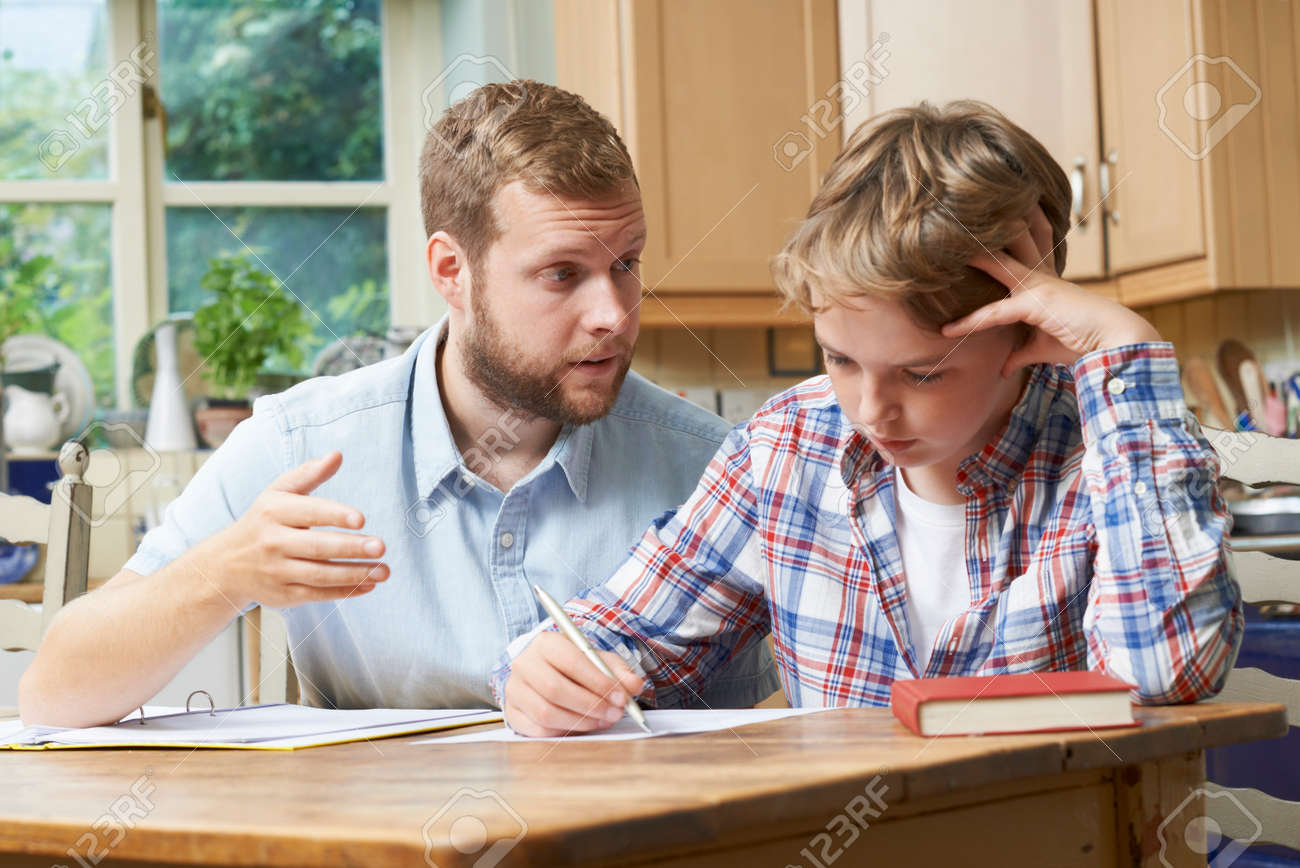 Male Home Tutor Helping Boy With Studies - 63089749 Male Home Tutor Helping Boy With Studies - 63089749