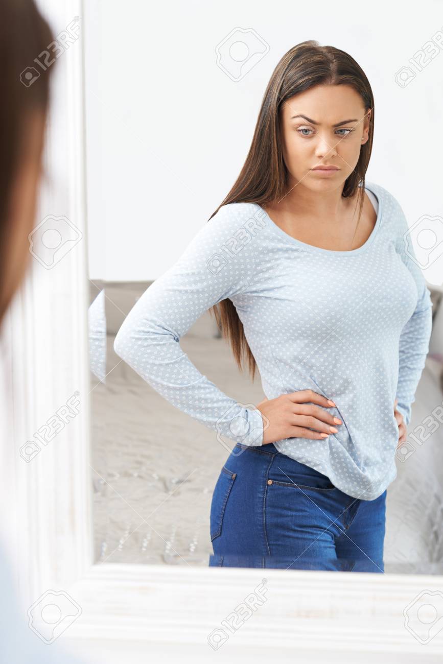 Unhappy Teenage Girl Looking At Reflection In Mirror Stock Photo, Picture  and Royalty Free Image. Image 67073844., image size:867x1300